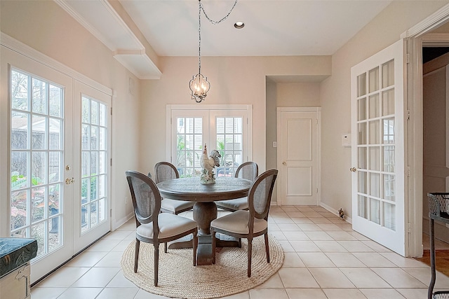 dining area with french doors, an inviting chandelier, and light tile patterned floors