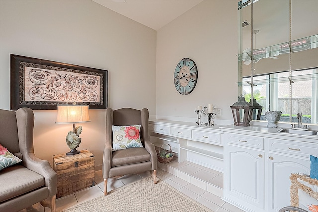 living area featuring light tile patterned flooring and sink