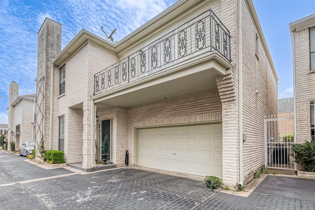 view of front facade featuring a balcony and a garage