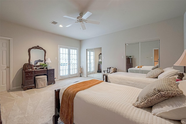 bedroom featuring access to exterior, a closet, light colored carpet, and ceiling fan