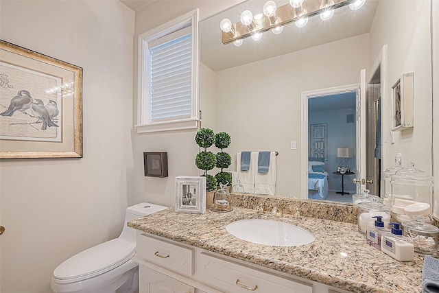 bathroom featuring vanity and toilet