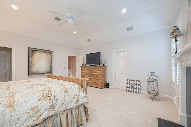 carpeted bedroom with ceiling fan, crown molding, a tray ceiling, and vaulted ceiling