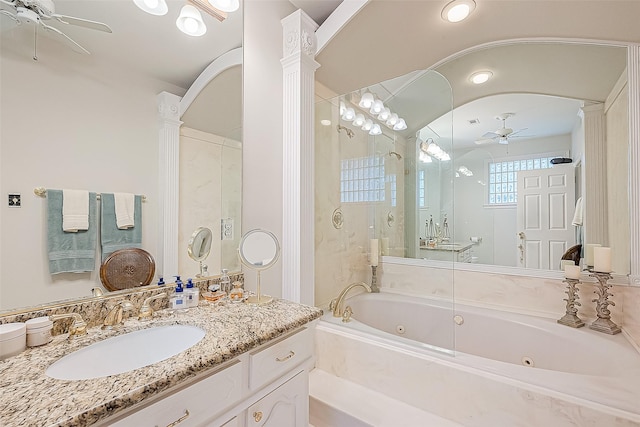 bathroom featuring ceiling fan, ornate columns, shower with separate bathtub, and vanity