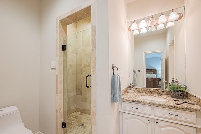 bathroom with vanity, an enclosed shower, and toilet