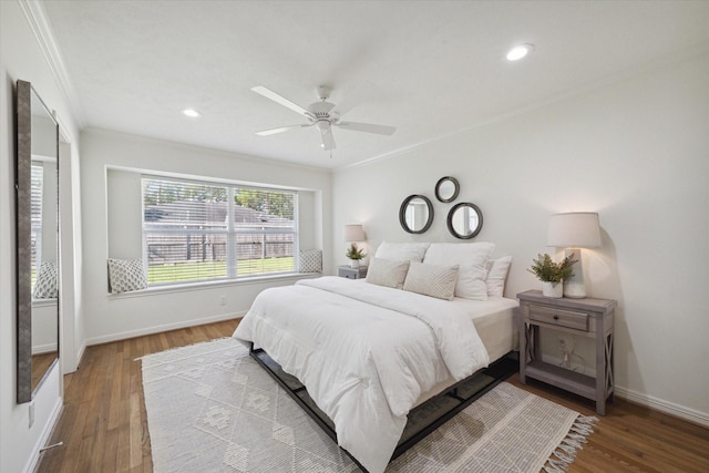 bedroom with hardwood / wood-style flooring, ceiling fan, and ornamental molding