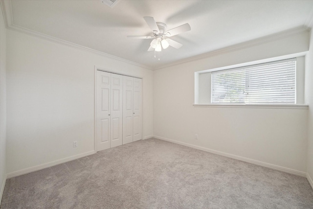 unfurnished bedroom featuring ceiling fan, a closet, and ornamental molding