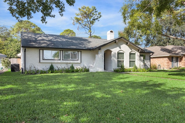 ranch-style house featuring central AC unit and a front lawn