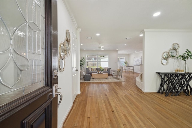 entryway featuring crown molding, light hardwood / wood-style flooring, and ceiling fan