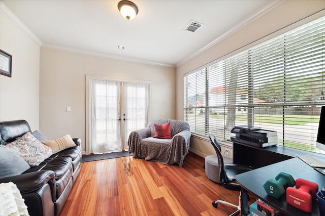 office featuring hardwood / wood-style flooring, plenty of natural light, ornamental molding, and french doors