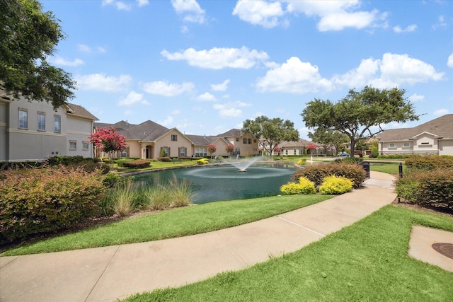 surrounding community featuring a water view