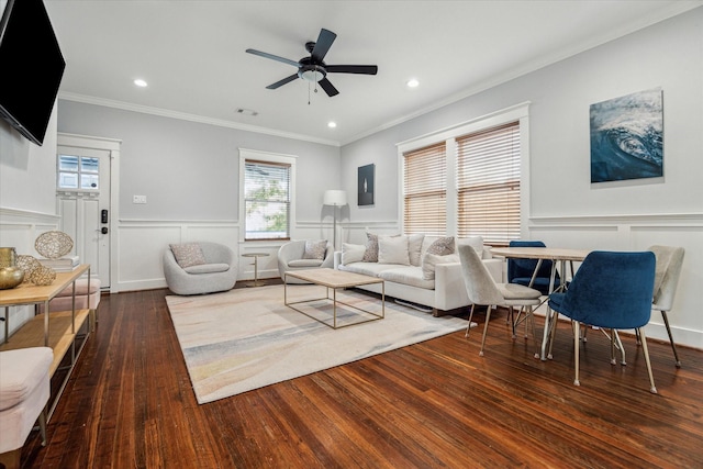 living room featuring ornamental molding, ceiling fan, and dark wood-type flooring