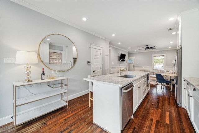 kitchen with a center island with sink, stainless steel appliances, dark hardwood / wood-style floors, white cabinets, and sink