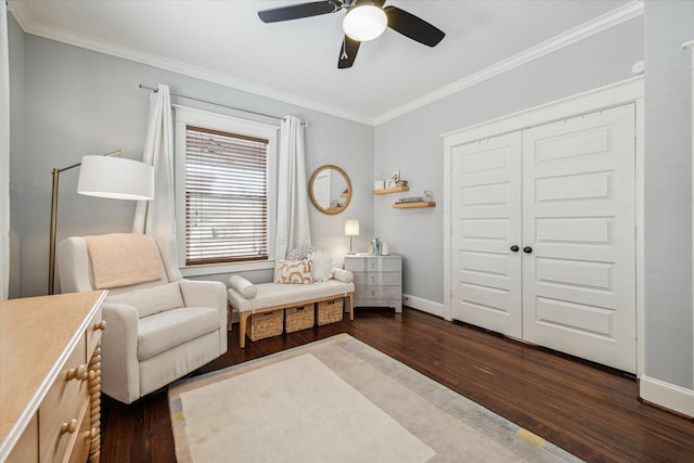 sitting room featuring dark wood-type flooring, ceiling fan, and ornamental molding