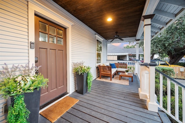 deck with covered porch, ceiling fan, and outdoor lounge area