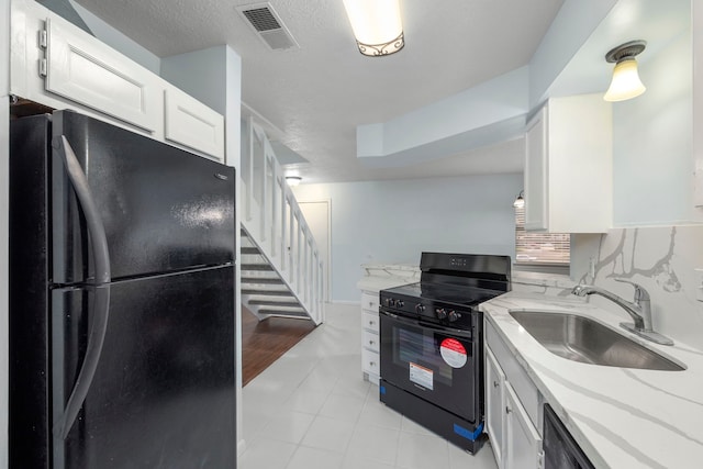 kitchen with sink, tasteful backsplash, black appliances, light stone countertops, and white cabinets