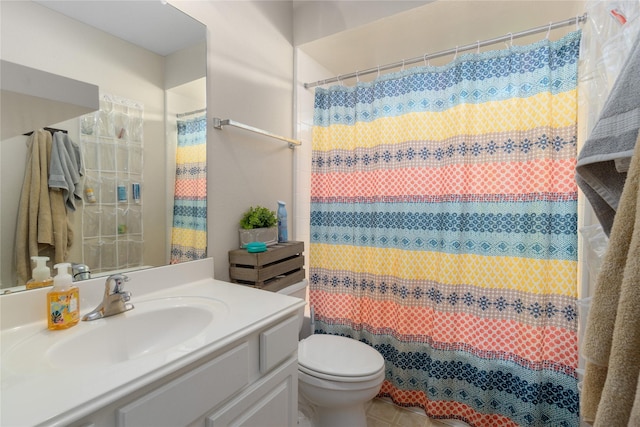 bathroom with curtained shower, vanity, and toilet