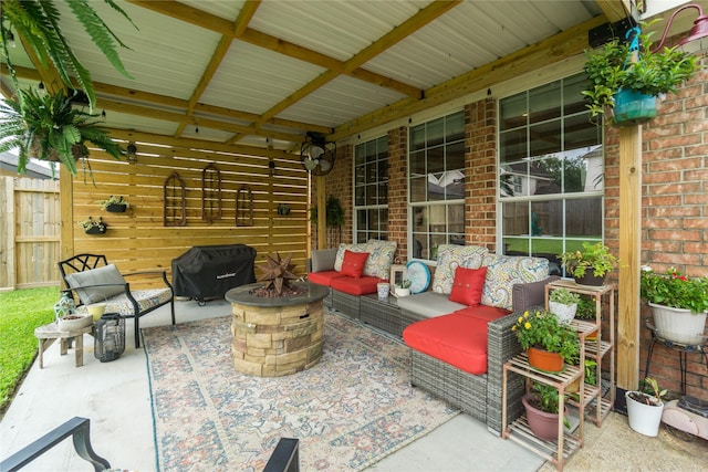 view of patio featuring area for grilling and an outdoor living space with a fire pit