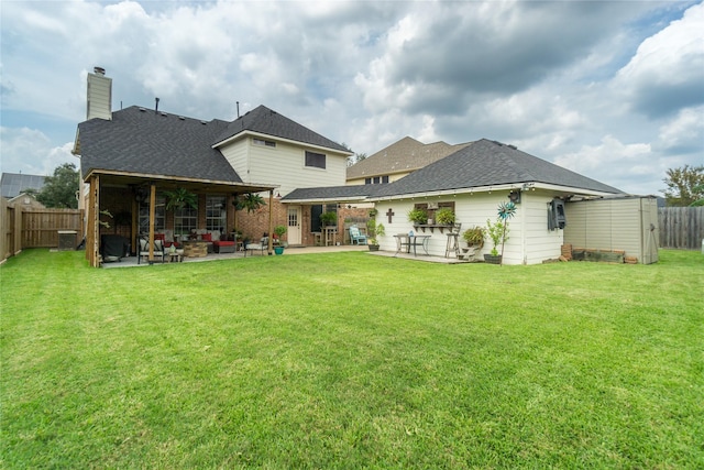 rear view of house with a patio area, ceiling fan, a yard, and cooling unit