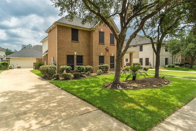 view of front of property featuring a front yard and a garage