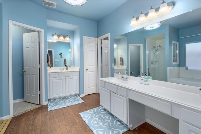 bathroom featuring separate shower and tub, vanity, and wood-type flooring