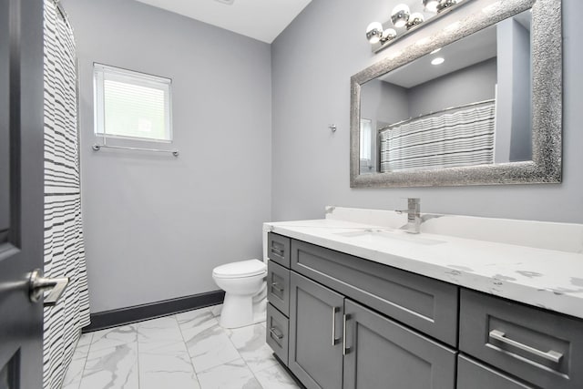 bathroom featuring curtained shower, vanity, and toilet