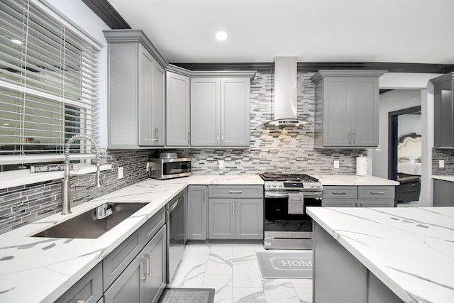 kitchen with light stone countertops, sink, wall chimney exhaust hood, stainless steel appliances, and gray cabinets