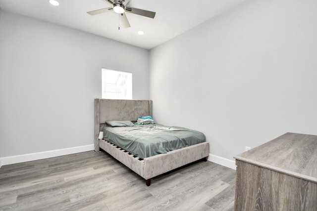 bedroom with ceiling fan and hardwood / wood-style flooring