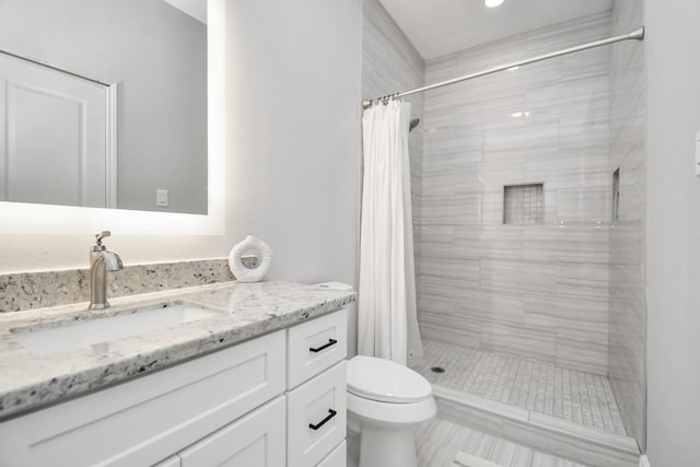 bathroom featuring a shower with curtain, vanity, and toilet