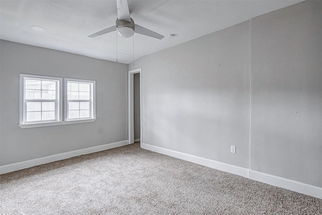 carpeted empty room featuring ceiling fan