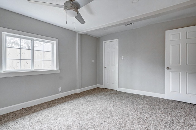 carpeted empty room featuring ceiling fan