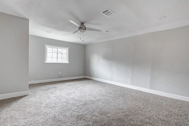 carpeted spare room featuring ceiling fan