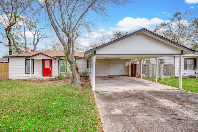 ranch-style home with a garage, a front yard, and a carport