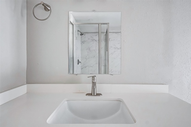 bathroom featuring a shower and vanity