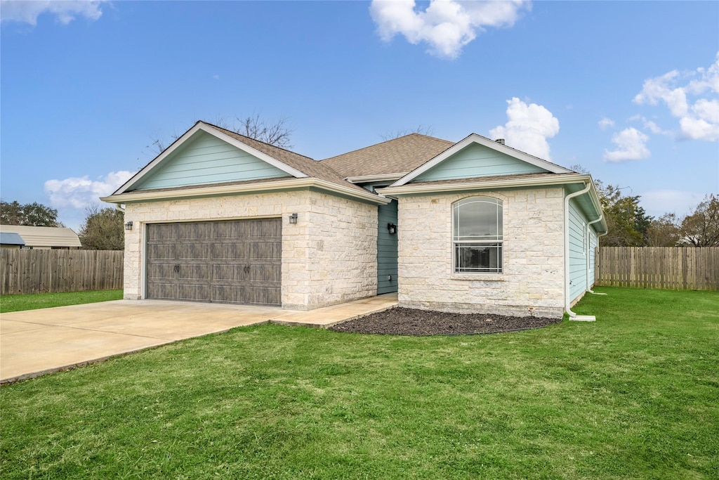 view of front facade with a garage and a front lawn