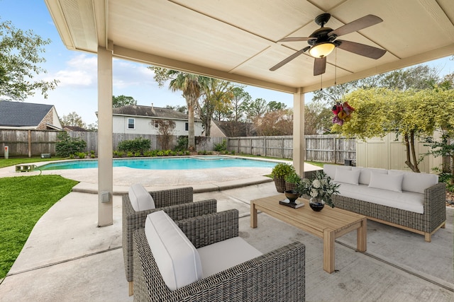 view of swimming pool with outdoor lounge area, ceiling fan, and a patio