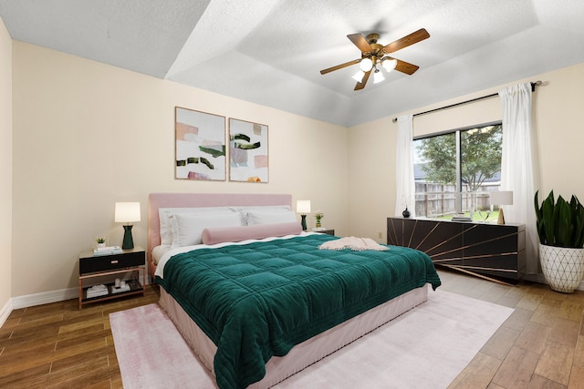 bedroom with a tray ceiling and ceiling fan