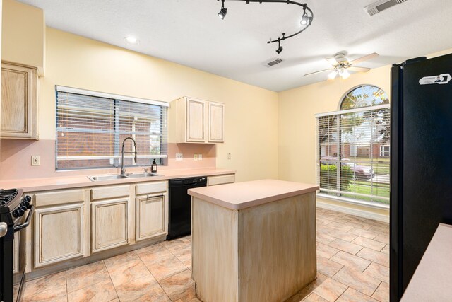 kitchen with ceiling fan, a center island, rail lighting, sink, and black appliances