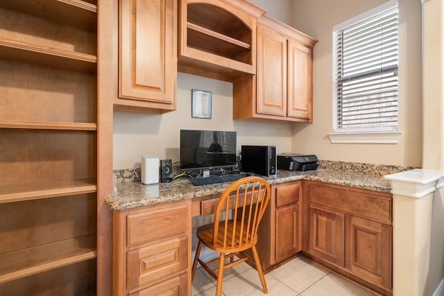 home office featuring built in desk and light tile patterned floors