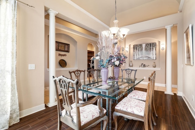 dining room with ornate columns and a chandelier