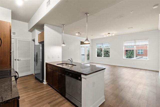 kitchen featuring sink, dark hardwood / wood-style floors, appliances with stainless steel finishes, decorative light fixtures, and dark brown cabinetry