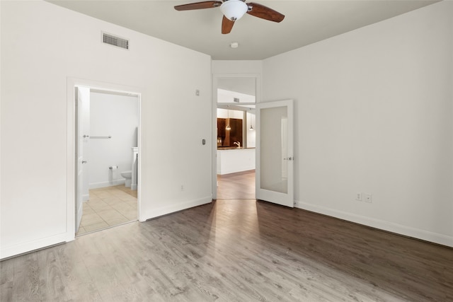 spare room featuring ceiling fan and light wood-type flooring