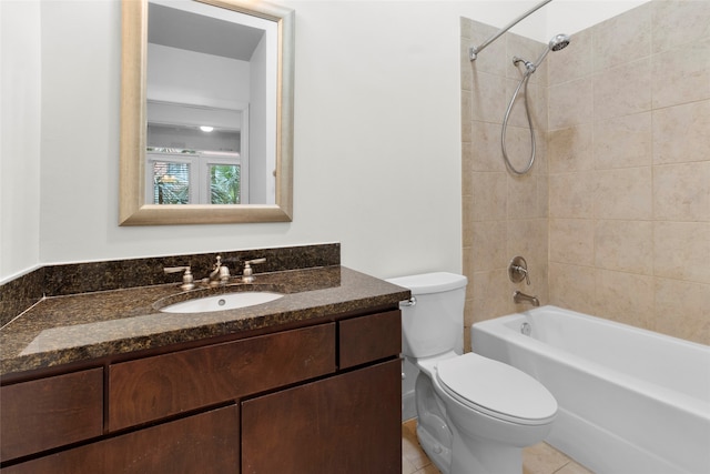 full bathroom featuring tile patterned floors, vanity, tiled shower / bath combo, and toilet