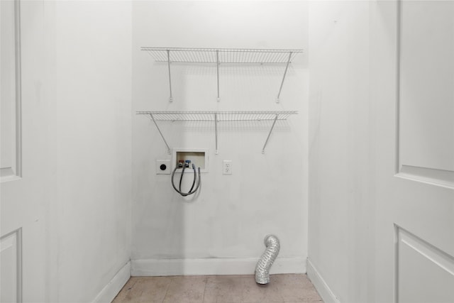 washroom featuring hookup for an electric dryer, washer hookup, and light tile patterned floors