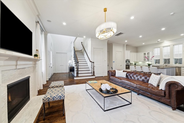 living room with light hardwood / wood-style floors and ornamental molding