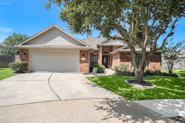 ranch-style home with a garage and a front lawn