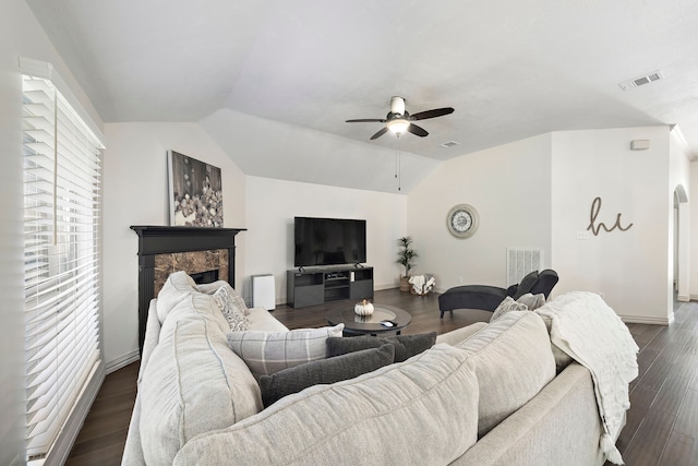 living room with dark hardwood / wood-style flooring, ceiling fan, and lofted ceiling