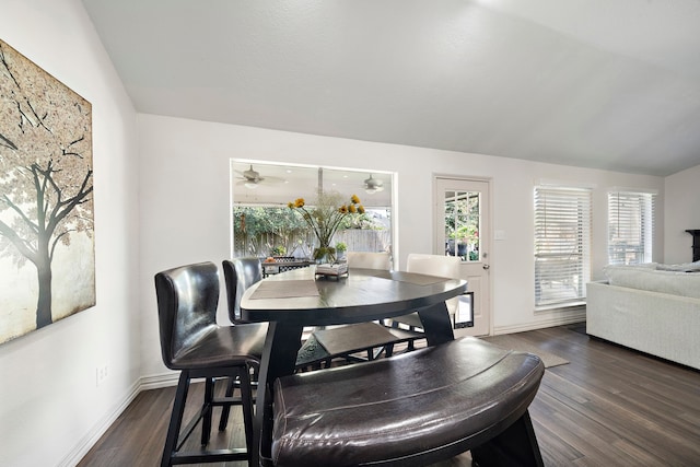 dining space featuring ceiling fan, dark hardwood / wood-style flooring, and lofted ceiling