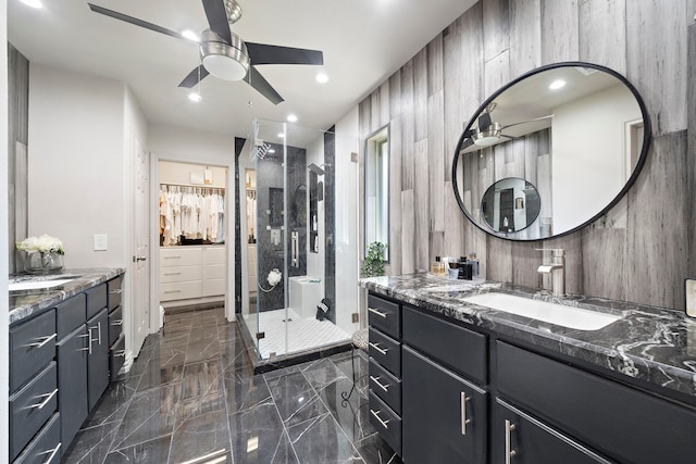 bathroom with ceiling fan, an enclosed shower, and vanity