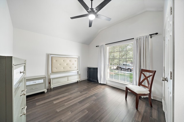 living area with ceiling fan, dark hardwood / wood-style flooring, and vaulted ceiling