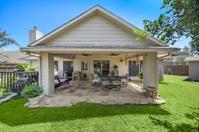 rear view of house with a yard, a patio, and ceiling fan